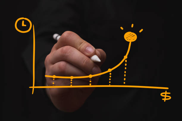 businessman drawing statistical graph of monetary growth, black background