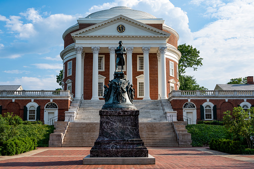 Charlottesville, Virginia, USA - June 6, 2021: The statue of Thomas Jefferson - \na U.S. Founding Father and president.  The statue is in front of the Rotunda at the University of Virginia, the university he founded and designed. The statue was crafted by Moses Ezekiel in 1910 and was a copy of the Jefferson statue in Louisville, Kentucky.
