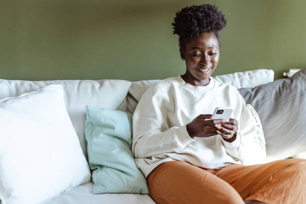 istock A beautiful African-American woman using a smart phone at home 1461801190