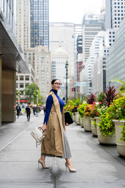istock Nicely dressed businesswoman seen exiting the building in Manhattan after work 1461801234