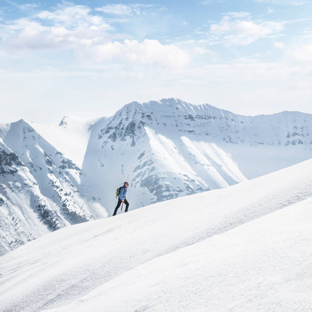 istock Young man hiking up the mountain in fresh snow 1461805458