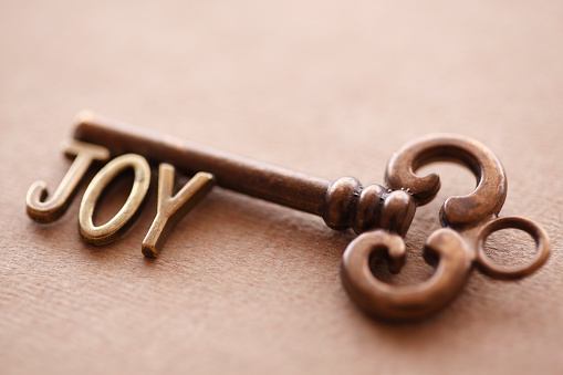 Metal key with JOY letters