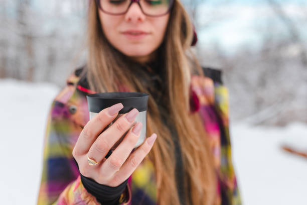istock Close-up of a young female hiker drinking hot tea while taking a break 1461812918