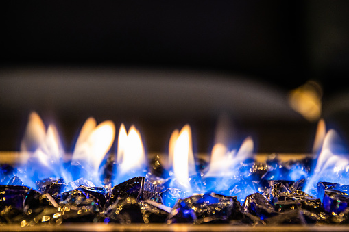 A close-up of the flames in a home fire pit in long exposure.
