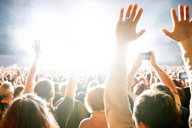 istock A crowd of people with raised arms during a concert. 1461816721