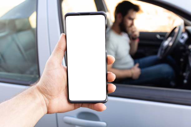 istock first person view of taxi app user using phone with white screen finding car blurred background, pov 1461818801