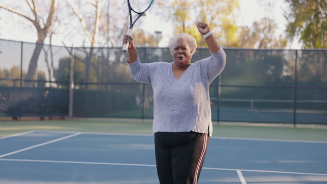 Senior Black Couple Playing Tennis