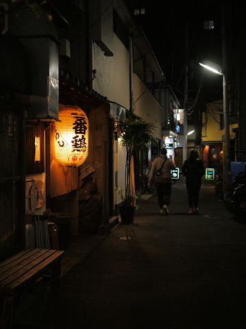 Tokyo, Japan - 05 05 2019. A red lantern hanging outside a restaurant.