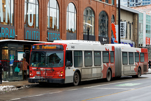 Ottawa, Canada - January 23, 2023: Public bus on Rideau street going to Parliament. Bus stop in downtown district
