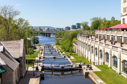 Ottawa, Canada - May 18, 2022: Rideau canal locks. Ottawa river, Alexandra bridge and Gatineau city of Quebec. Popular travel destination