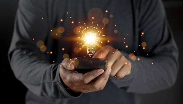 istock hand holding light bulb. idea concept with innovation and inspiration. Bulb light drawing idea in hand 1461846017