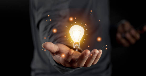 istock hand holding light bulb. idea concept with innovation and inspiration. Bulb light drawing idea in hand 1461846096