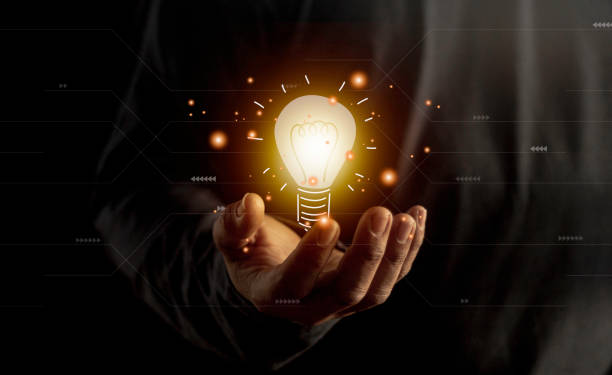 istock hand holding light bulb. idea concept with innovation and inspiration. Bulb light drawing idea in hand 1461846112