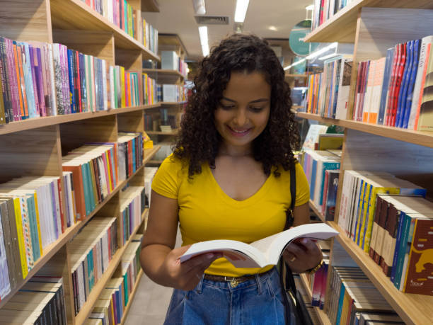 istock latin american woman reading book 1461853943