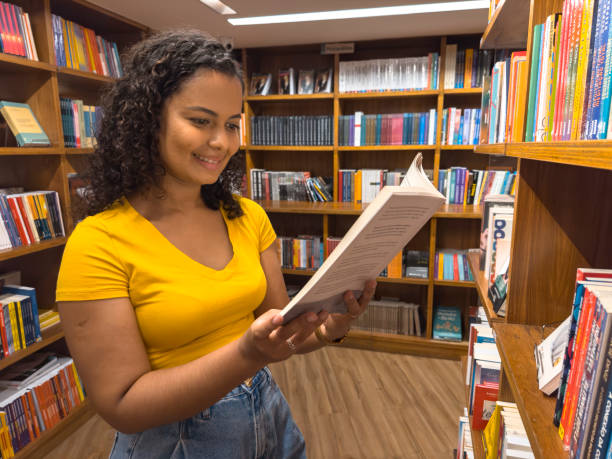 istock latin american woman reading book 1461853969