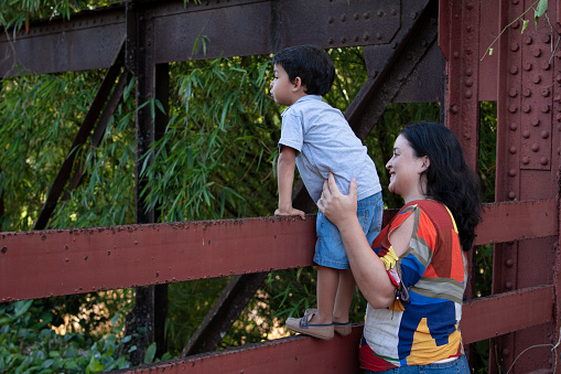 mother playing with son outdoors