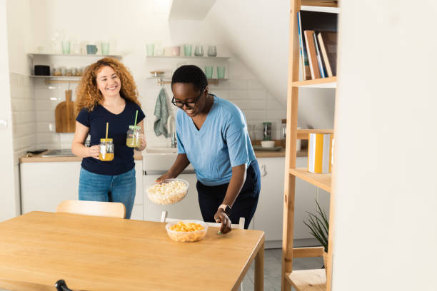 istock Happy two female friends having fun at home 1461856182