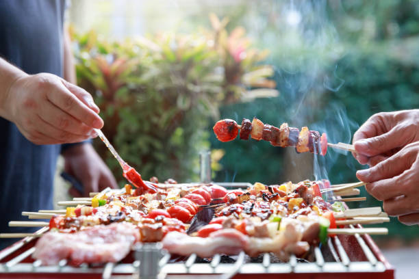 istock Friends having party and cooking barbecue in gardern. 1461858461