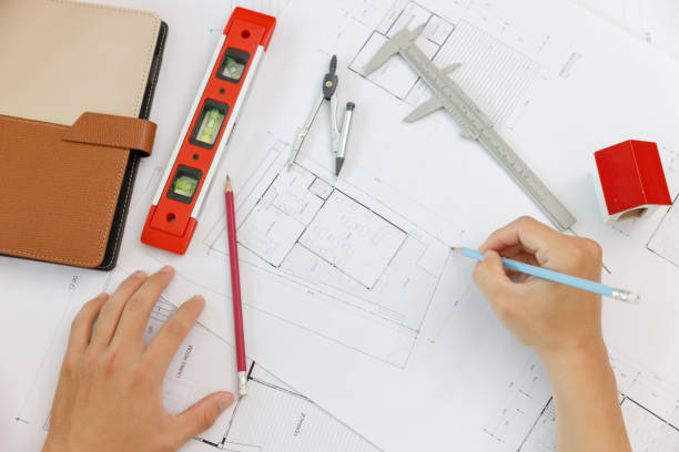 istock Engineer and Architect concept, Top view of Engineer Architects  and Interior designer office team working with blueprints 1461858484