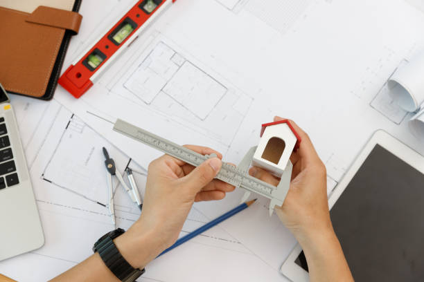 istock Engineer and Architect concept, Engineer Architects  and Interior designer working with house model 1461858487