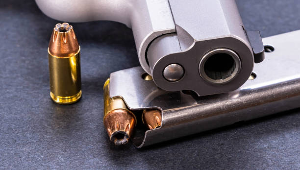 istock A bullet with a loaded magazine and a pistol 1461858527