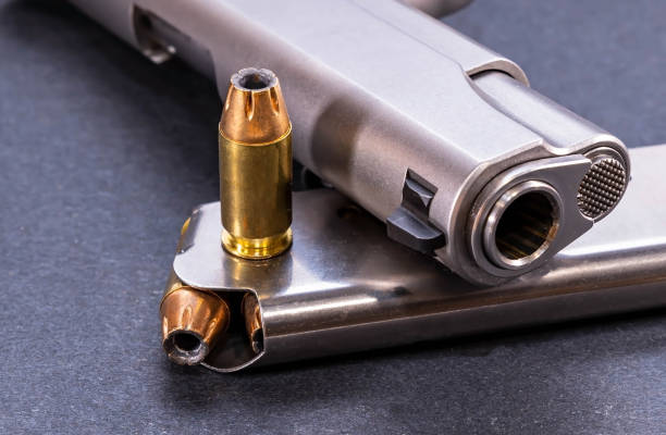 istock A bullet with a loaded magazine and a pistol 1461858660