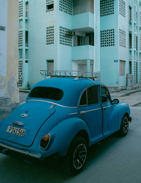 Havana, Cuba - December 9th 2022: Classic vintage cars driving along at old Havana. Old Havana is one the most unique and charming places for tourists in the world for its time-capsuled buildings and lifestyles.
