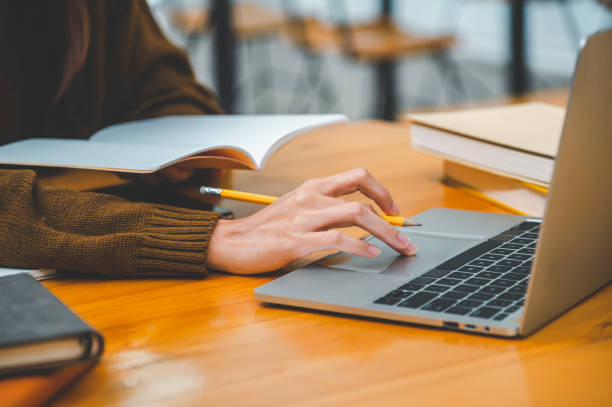 istock students working on laptop while studying online, distance learning, and keeps up to date on the global coronavirus pandemic. 1461889797