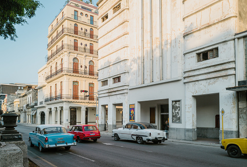 Havana, Cuba - December 12th 2022: Classic vintage cars driving along at old Havana. Old Havana is one the most unique and charming places for tourists in the world for its time-capsuled buildings and lifestyles.