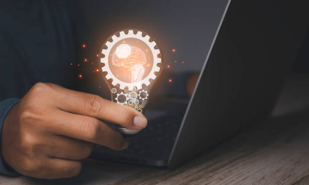 istock Businessman holding light bulbs with gear and Brain, Innovation and digital transformation. 1461897316