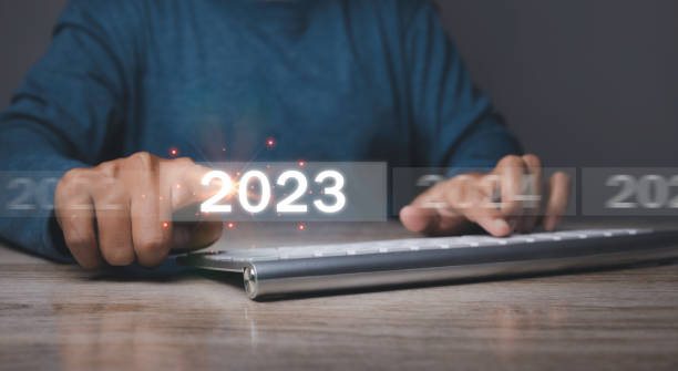 istock Welcome year 2023. Businessman hand pressing button New Year 2023. 1461897850