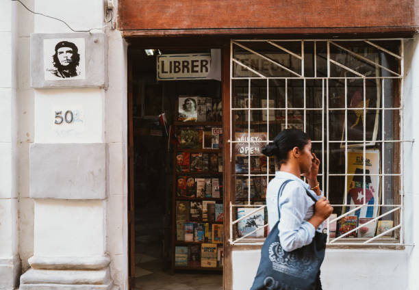 Havana,Cuba, December 12th 2022: Local cuban walking past a book store at old Havana. Book store is not a common scene in Cuba.