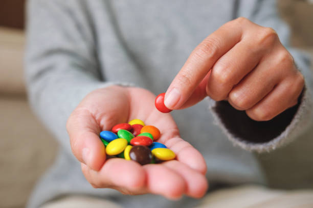 istock Closeup image of hands holding colorful chocolate candy 1461903410