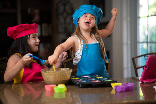 istock Two girls having a lot of fun while preparing cupcakes 1461905561