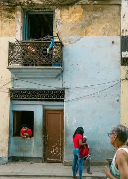 Havana, Cuba - December 10th 2022: Locals and tourists enjoying cuban daily life on the street of old Havana. Havana is one of the most unique places to visit for its time-capsuled buildings and cars and lifestyles.