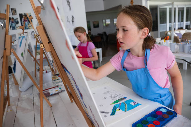 istock Two young girls have fun during their art class 1461911759
