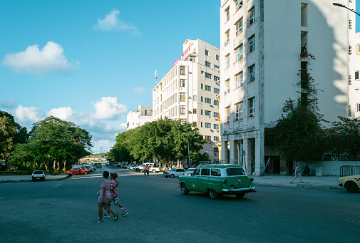 Havana, Cuba - December 10th 2022: Locals and tourists enjoying cuban daily life on the street of old Havana. Havana is one of the most unique places to visit for its time-capsuled buildings and cars and lifestyles.