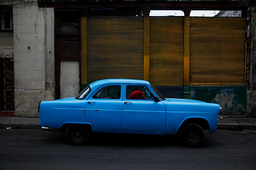 A blue car on a street in Havana