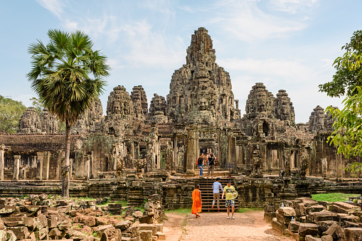 Bayon Temple, Khmer temple related to Buddhism at Angkor in Cambodia. under blue sunny summer sky. 102 MPixel Hasselblad X2D Architecture Shot. Bayon Temple inside the ancient City of Angkor Thom. Bayon (Banyan) Khmer Temple Angkor Thom City close to Angkor Wat Archaeological Area, Siem Reap, Cambodia, Southeast Asia, Asia.