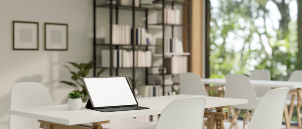 istock Portable tablet mockup with wireless keyboard on table in modern minimal co-working room. 1461922355