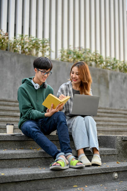 istock Happy young Asian college students are sharing ideas, working on their school project together 1461922778