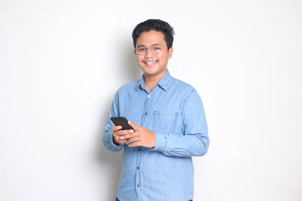 istock Asian man holding mobile phone 1461924641