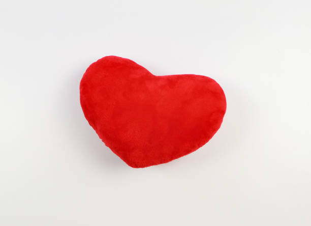 istock flat lay of red heart pillow on white background. 1461939519