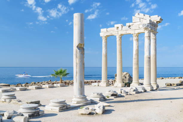 Awesome ruins of the Temple of Apollo in Side, Turkey Awesome ruins of the Temple of Apollo on the Mediterranean Sea coast in Side, Turkey. The Roman temple is a popular tourist attraction in Turkey. Amazing view of columns on sunny day. temple of apollo antalya province stock pictures, royalty-free photos & images