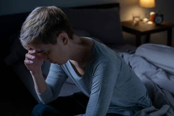 istock Depressed senior Asian woman sitting in bed cannot sleep from insomnia 1461950410