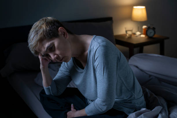 istock Depressed senior Asian woman sitting in bed cannot sleep from insomnia 1461950419