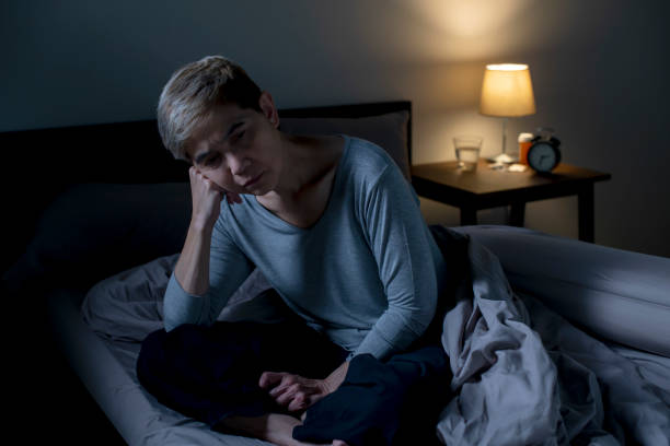 istock Depressed senior Asian woman sitting in bed cannot sleep from insomnia 1461950954