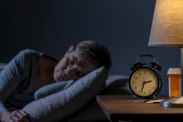 istock Depressed senior woman lying in bed cannot sleep from insomnia 1461951018