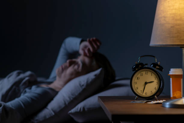 istock Depressed senior woman lying in bed cannot sleep from insomnia 1461951543
