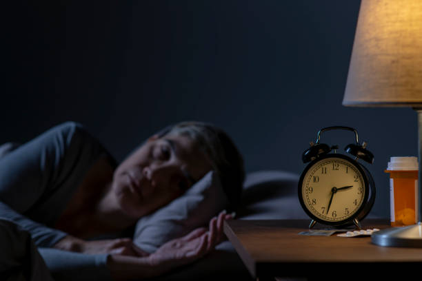 istock Depressed senior woman lying in bed cannot sleep from insomnia 1461951556